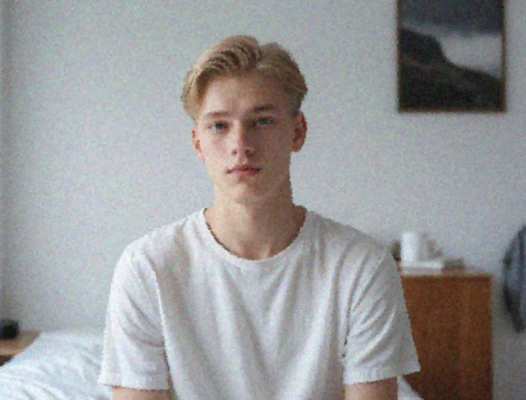 blurry and grainy image of a young man in white tshirt